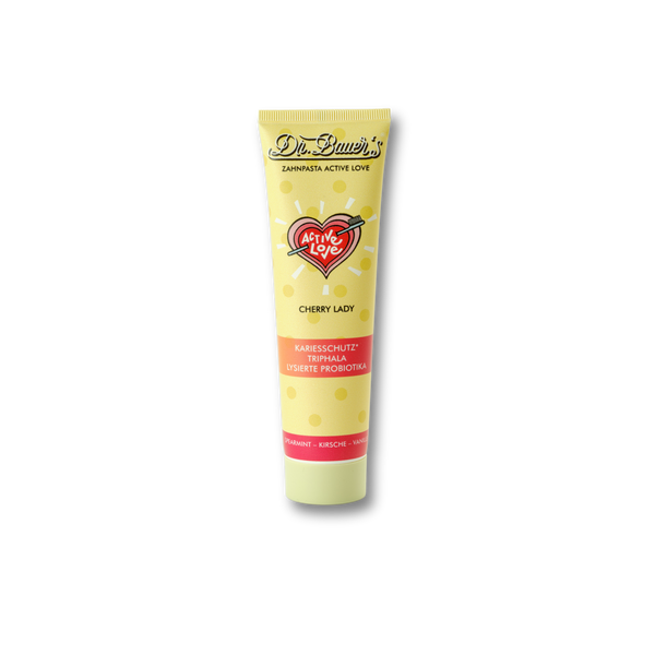 Dr. Bauer's Zahnpasta Active Love Cherry Lady 90ml in einer gelben Tube wird vor einem schwarzen Hintergrund dargestellt.