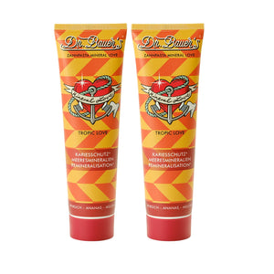 Zwei Tuben Dr. Bauer's Zahnpasta Mineral Love Tropic Love (je 90ml, 2er Pack) mit orangefarbenen geometrischen Mustern und einem Herz-Anker-Design.