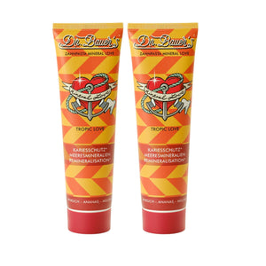 Zwei Tuben Dr. Bauer's Zahnpasta Mineral Love Tropic Love (je 90ml, 2er Pack) mit orangefarbenen geometrischen Mustern und einem Herz-Anker-Design.