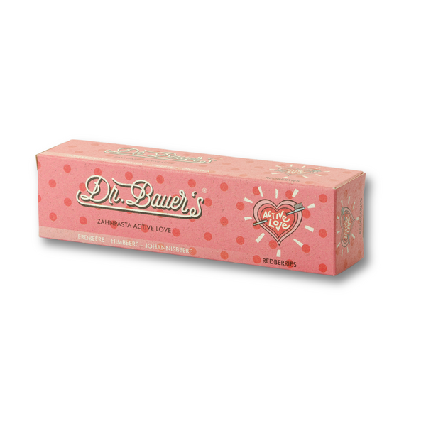 Dr. Bauer's Zahnpasta Active Love Redberries 90ml kommt in einer rosafarbenen Dose mit Beeren-Illustrationen, Tupfen und bietet Zahnfleischschutz für gesundes Zahnfleisch.