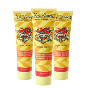 Das Dr. Bauer's Zahnpasta Mineral Love Caribic Dream 90ml 3er Pack enthält drei gelbe Tuben mit einem Herz- und Ankerlogo - ideal für empfindliche Zähne, angereichert mit Meeresmineralien.