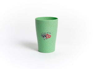 Ein grün gesprenkelter Dr. Bauer's Zahnputzbecher Stroh mit THIN VEGE Logo und kleinem Text, hergestellt aus einer Stroh-Kunststoff-Mischung, abgebildet auf weißem Hintergrund. Erhältlich im 4er-Pack.