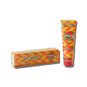 Dr. Bauer’s Zahnpasta Mineral Love Tropic Love 90 ml wird in einer orange-gelben Schachtel und Tube mit Herz, tropischem Fruchtmotiv und „Meeresmineralien“-Etikett geliefert – ideal für empfindliche Zähne.