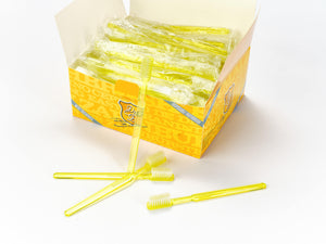 Eine Schachtel Dr. Bauer's Einmalzahnbürsten mit Zahnpasta 100er Packung GELB, mit mehreren einzeln verpackten gelben Zahnbürsten und einigen unverpackten vorne.