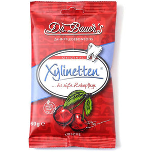 Dr. Bauer's Xylinetten Kirsche 60g im roten Beutel, mit Kirsch- und Zahngrafik, bietet Zahngesundheit und echten Kirschgenuss.